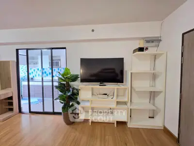 Modern living room with sleek TV setup and stylish shelving, perfect for contemporary living.