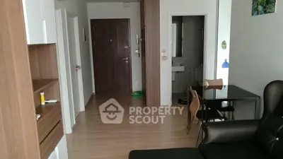 Modern apartment interior with open living and dining area, wooden flooring, and stylish furniture.