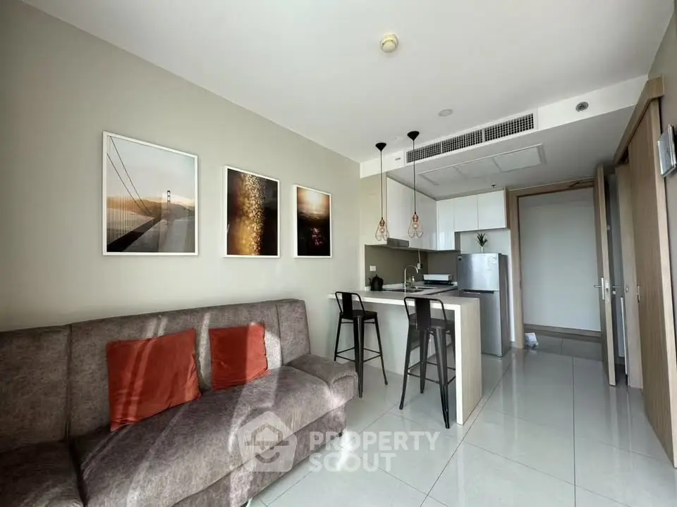 Modern living room with open kitchen and stylish decor in a contemporary apartment.