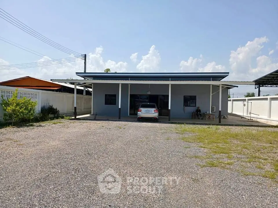 Charming single-story home with spacious driveway and carport, perfect for family living.