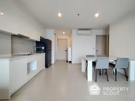 Modern kitchen and dining area with sleek design and ample natural light