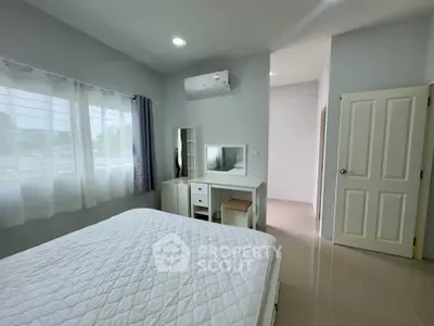 Bright and airy bedroom with modern furnishings and air conditioning