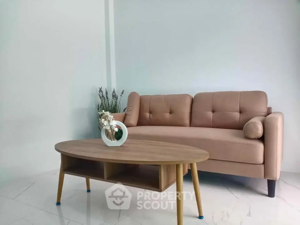 Modern living room with stylish beige sofa and elegant wooden coffee table.