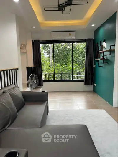 Modern living room with large window and stylish decor