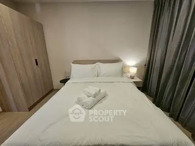 Cozy bedroom with modern decor and soft lighting, featuring a comfortable bed and stylish wardrobe.