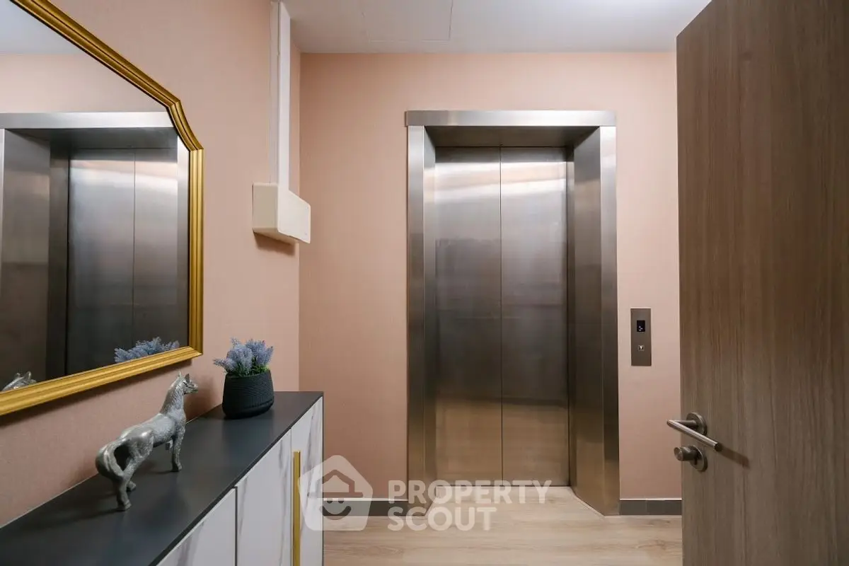 Modern elevator entrance with stylish decor and wooden accents