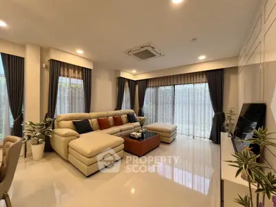 Luxurious living room with elegant decor and large windows for natural light.