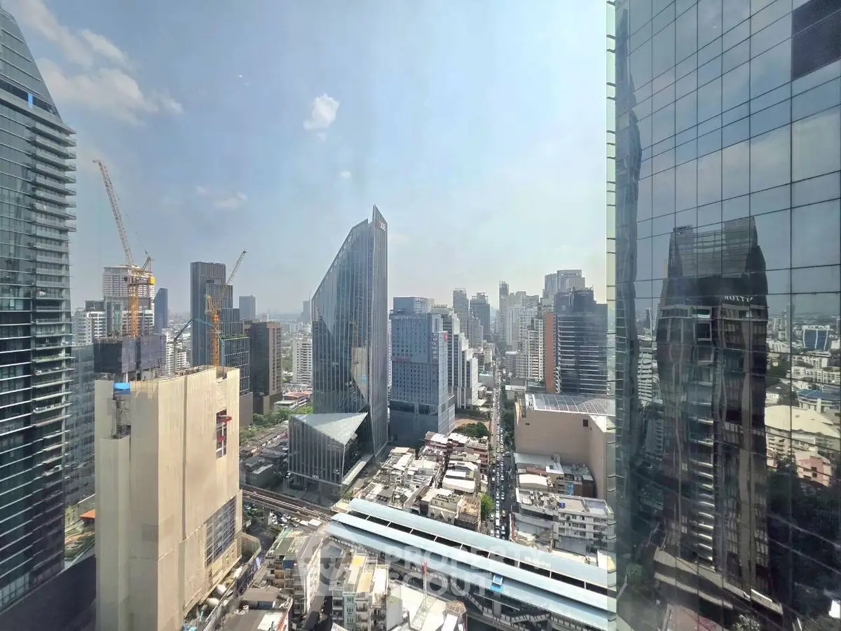 Stunning cityscape view from a high-rise building showcasing modern architecture and urban skyline.