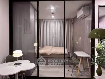 Modern bedroom with glass partition, stylish decor, and cozy ambiance