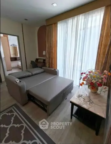 Cozy living room with sofa bed and elegant decor, perfect for modern living.