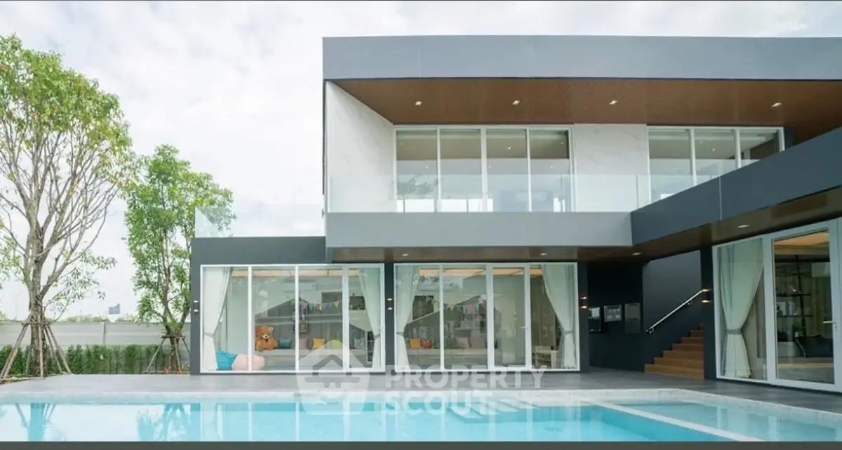 Modern luxury villa with pool and large glass windows, perfect for contemporary living.
