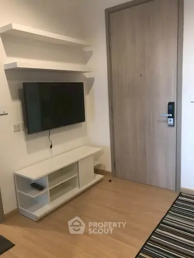 Modern living room with wall-mounted TV and sleek storage unit