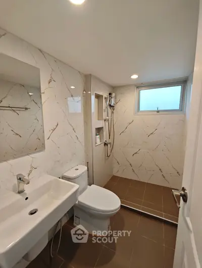 Modern bathroom with elegant marble walls and sleek fixtures