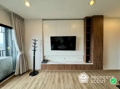 Modern living room with wall-mounted TV and wooden flooring