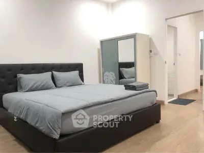 Modern bedroom with sleek design and comfortable bedding in a stylish apartment.