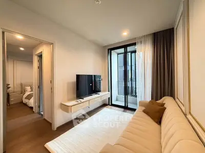 Modern living room with elegant decor and balcony access in a stylish apartment.