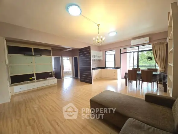 Spacious open-plan living and dining area with modern decor and natural light.