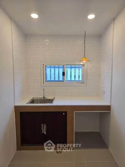Modern minimalist kitchen with sleek design and ample natural light.