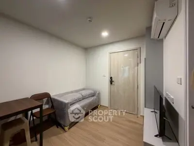 Modern living room with minimalist furniture and air conditioning in a cozy apartment.