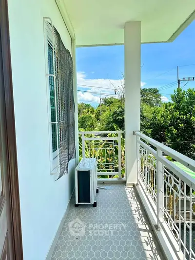 Charming balcony with lush green view and modern railing design