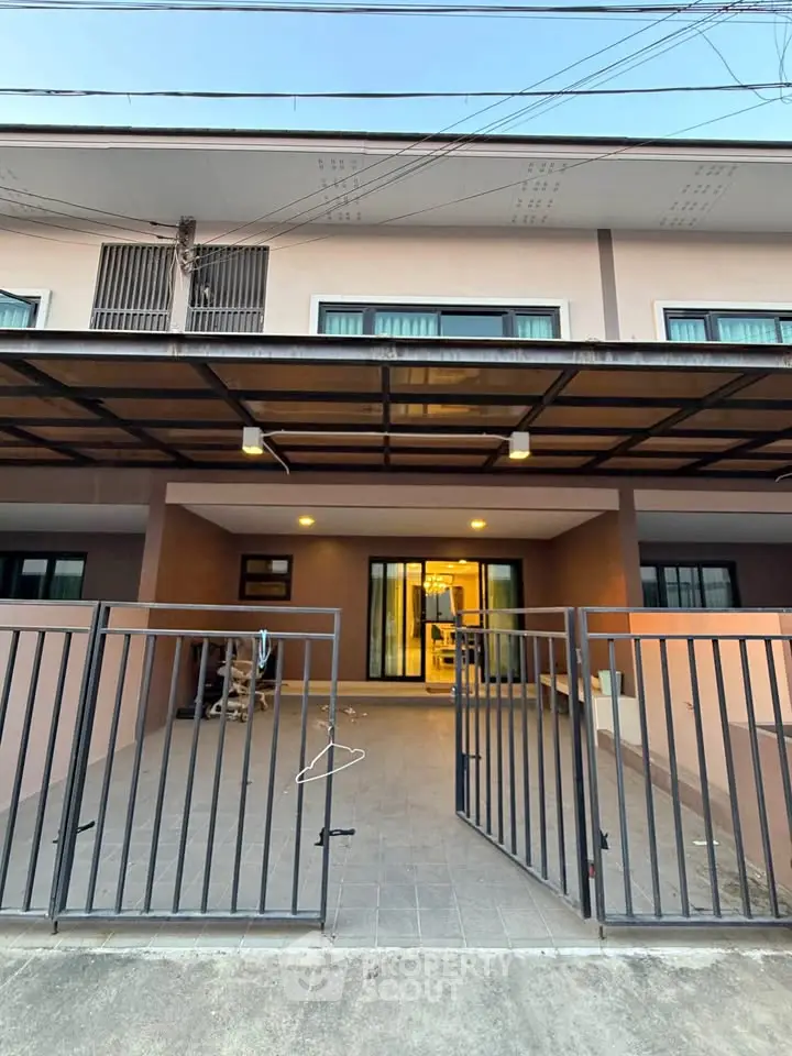 Charming two-story townhouse with gated entrance and spacious front patio, perfect for modern living.