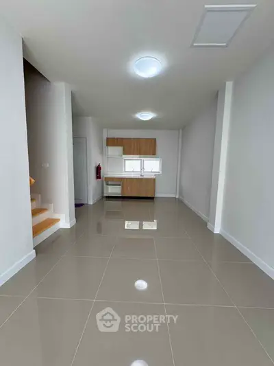 Spacious modern kitchen with sleek tile flooring and minimalist design