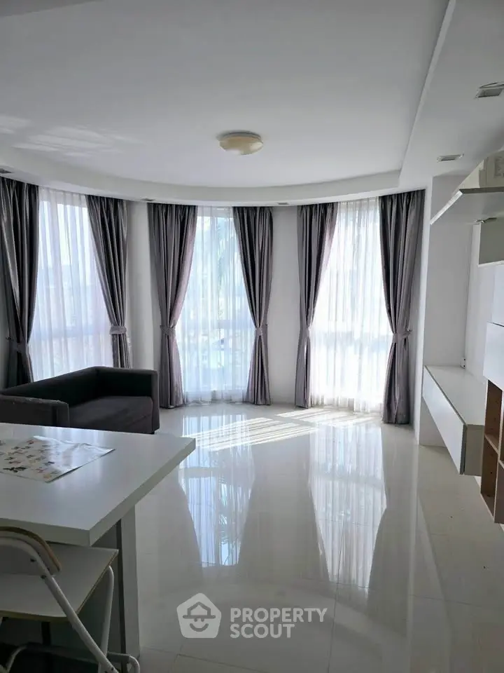 Spacious living room with large windows and modern decor