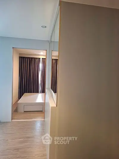 Modern bedroom with sleek design and large window for natural light.