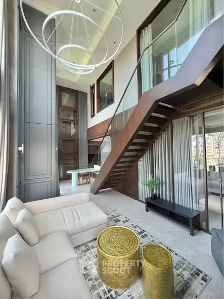 Luxurious modern living room with high ceilings and elegant staircase