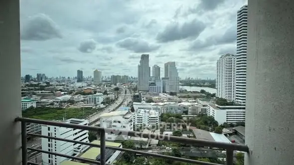 Stunning cityscape view from a high-rise balcony overlooking urban skyline.