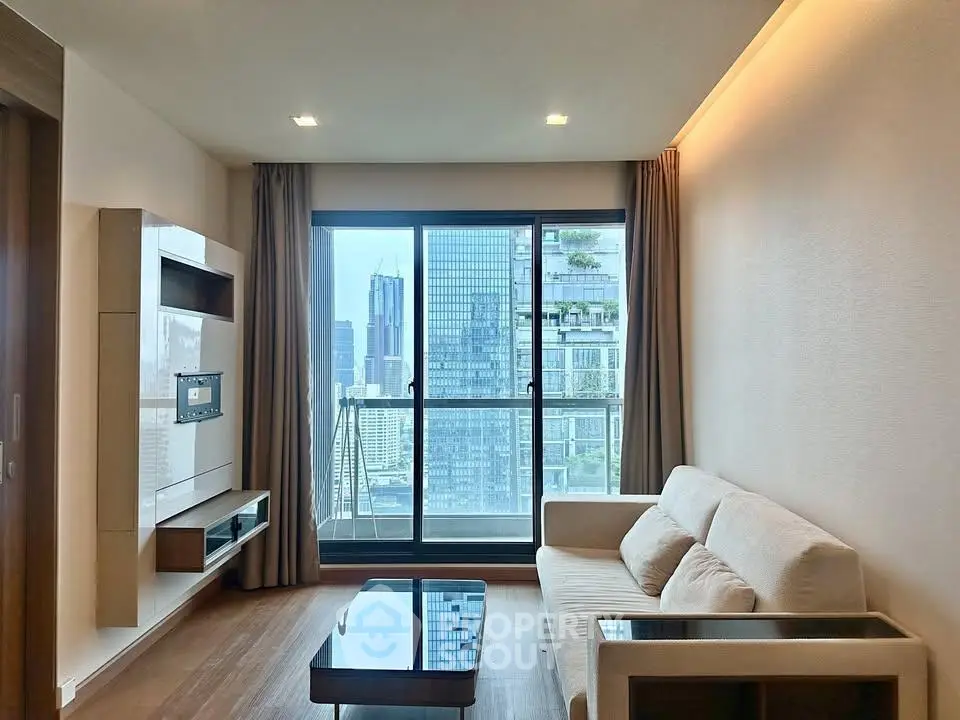 Modern living room with city view, featuring sleek furniture and large windows for natural light.