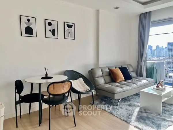 Modern living room with stylish decor and city view, featuring a cozy sofa and dining area.