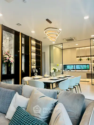 Luxurious open-plan living and dining area with modern kitchen and elegant lighting