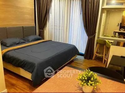 Modern bedroom with cozy bed, stylish decor, and elegant curtains in a contemporary apartment.