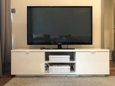 Modern living room with sleek TV stand and flat-screen television