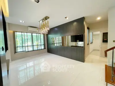 Spacious modern living room with elegant chandelier and large windows