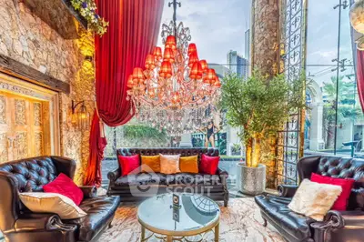 Luxurious living room with elegant chandelier and plush seating in a sophisticated setting.