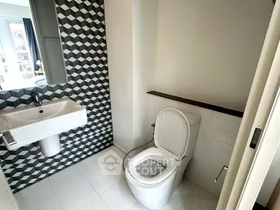 Modern bathroom with geometric tile design and sleek fixtures