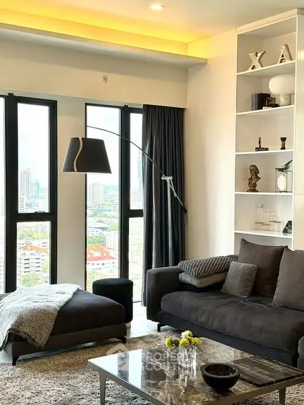 Modern living room with city view, stylish decor, and cozy seating area.