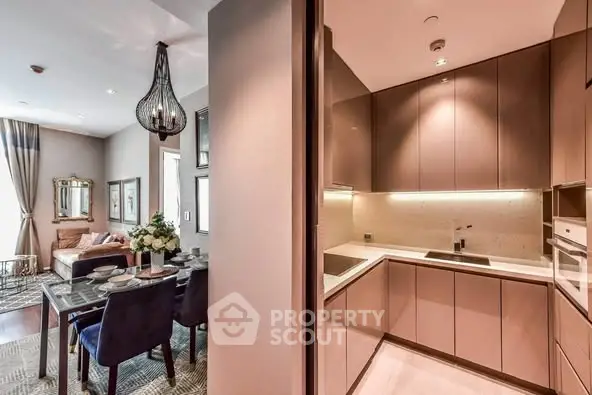 Luxurious open-plan living and kitchen area with elegant dining setup and modern lighting.