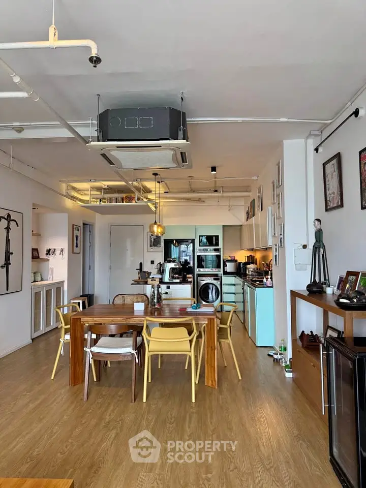 Spacious open-plan living and dining area with modern kitchen and stylish decor.