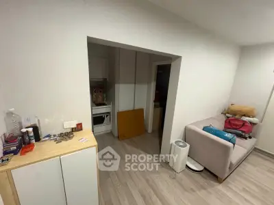 Cozy living space with modern decor and compact kitchen area