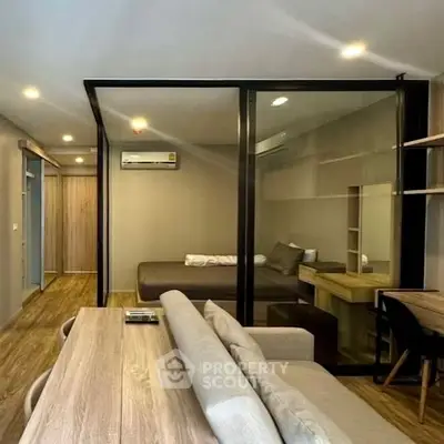 Modern studio apartment with glass partition and stylish furnishings