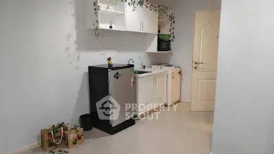 Modern compact kitchen with sleek appliances and minimalist design