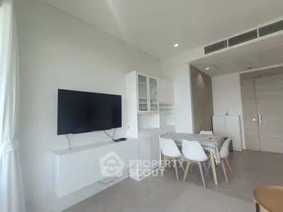 Modern living room with sleek furniture and wall-mounted TV