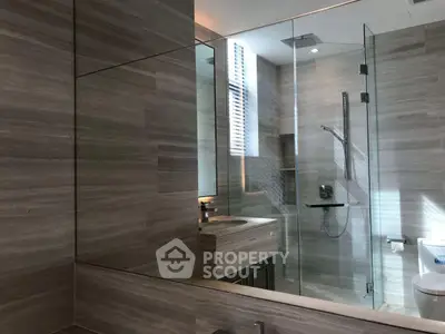 Luxurious modern bathroom with glass shower and elegant fixtures