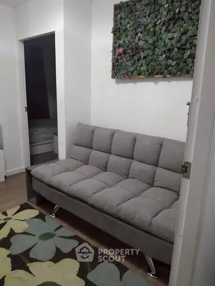 Cozy living room with modern gray sofa and floral rug