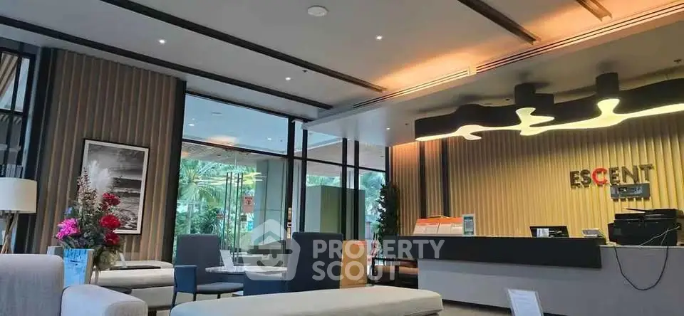 Modern lobby area with stylish seating and contemporary lighting in a luxury residential building.