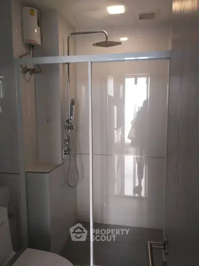 Modern bathroom with glass shower enclosure and sleek fixtures