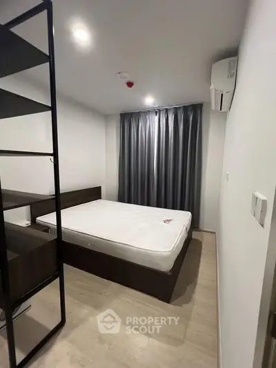 Modern minimalist bedroom with sleek design and ample natural light, featuring a comfortable bed and stylish decor.